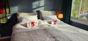 a bedroom with a bed with two pillows on it at Between Fjord og Glacier in Ålfoten