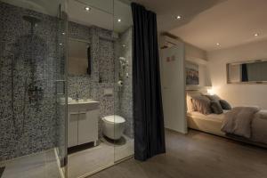 a bathroom with a shower and a bed and a sink at ROKOS SUPERIOR DOWNTOWN ROOMS - comfortable rooms with private bathrooms - perfect location for exploring Diocletian's Palace and the gastronomy of Split within walking distance in Split