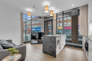 a living room with a couch and a table at New Modern Apartment near Heathrow Airport in Yiewsley