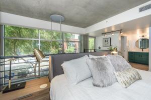 a bedroom with a bed and a large window at King Size Luxury Loft Petco-Park-Downtown SD in San Diego