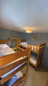 a group of bunk beds in a room at Casa da Pri Suítes in Pôrto de Pedras