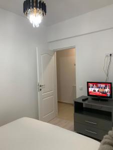 a bedroom with a bed and a desk with a television at Slatina RECEA RESIDENCE in Slatina +7 photos