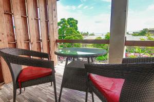 a patio with a table and chairs on a balcony at Kuti Apartments in Abeokuta