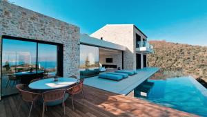 a house with a pool and a table and chairs at Villa Orama Corfu in Karyótikon