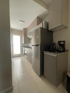 a kitchen with a stainless steel refrigerator and cabinets at Departamento Maipú Ruta del vino in Maipú