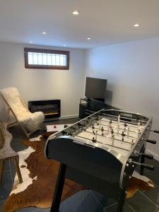 a living room with a large foosball table at Maison Amore Serre Chevalier in Saint-Chaffrey