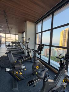 a gym with a row of exercise bikes and windows at IorubaStudio in Salvador