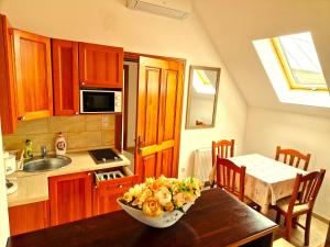 a kitchen with a table with a bowl of food on it at Villa Gracia in Balatongyörök