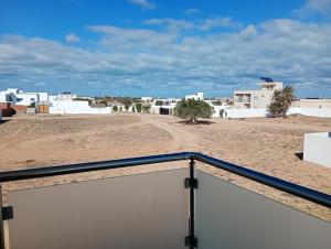 a view from a balcony of a beach with white buildings at Villa roche in Awlād ‘Umar