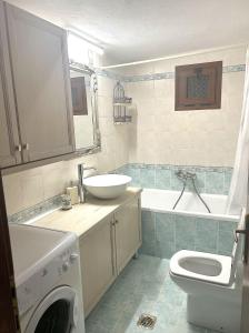 a bathroom with a sink and a toilet and a tub at The Hidden Ranch in Asómatoi +9 photos