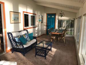 a living room with a couch and a dining table at Waterfront house in Falmouth