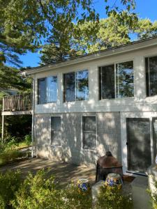 a white house with windows and a porch at Waterfront house in Falmouth