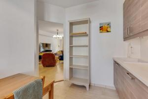 a kitchen with a door into a room with a sink at Accommodation closest to Disneyland in Serris +56 photos