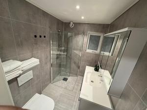 a bathroom with a shower and a toilet and a sink at Apartment with a beautiful view in the center of Ålesund in Ålesund +28 photos
