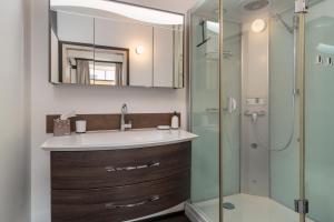a bathroom with a sink and a shower at NA-Home Kitzbühel Hornbichl in Kitzbühel +19 photos