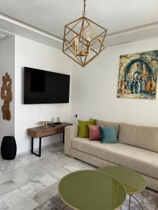 ein Wohnzimmer mit Sofa und Tisch in der Unterkunft Prestige stay with swimming pool in Agadir