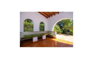an empty bench in a room with arched windows at Es Calo De N'aladern in Capdepera