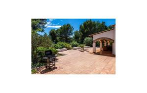 a patio with a building and a chair on it at Es Calo De N'aladern in Capdepera