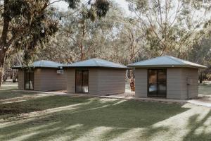 two small buildings in a yard with trees at The Paddock at Ulupna - The Paddock at Ulupna - 10 minutes from Cactus Country in Ulupna