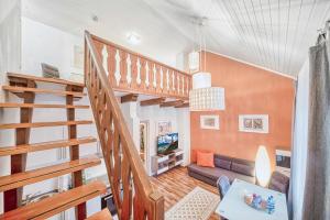 a living room with a staircase and a couch at Galerie-Apartment am Kurgarten in Bad Reichenhall