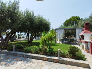 a view of a garden with trees and a pavilion at Beachfront Eva's House in Karianí