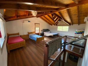 a room with two beds and a living room at Cabaña EL GALLO in Villa General Belgrano +24 photos