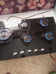 a stove top with four burners on top of it at rafat house in Amman +11 photos