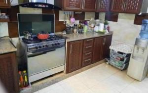a kitchen with a stove and a counter top at rafat house in Amman
