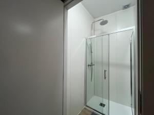 a shower in a bathroom with a glass shower stall at Romantic Downtown Studio in Vila do Conde