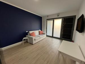 a living room with a couch and a table at Romantic Downtown Studio in Vila do Conde