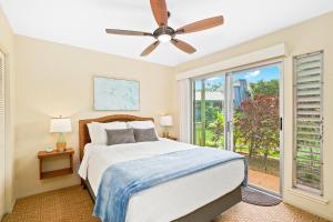 a bedroom with a bed and a ceiling fan at Keiki Honu Kauai Princeville 2BR2BA King+Queen bed in Princeville +29 photos