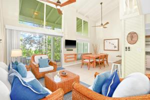 a living room with wicker furniture and a dining room at Keiki Honu Kauai Princeville 2BR2BA King+Queen bed in Princeville