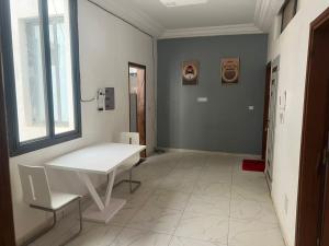 a room with a white table and a window at L Appartement Prestige- Darou Salam Immo in Thiès