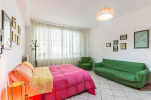 1 dormitorio con 1 cama y 1 sofá verde en Il Paesino - La Veranda en Licodia Eubea