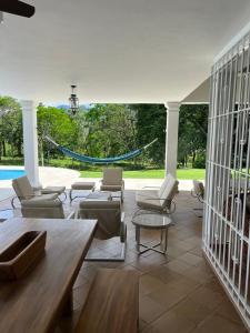 a living room with chairs and tables and a pool at PASEOS GRANDES!!!-14 PAX-Hacienda Manantiales Paraíso Natural in Fredonia