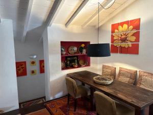 a dining room with a wooden table and chairs at Courela do Monte Novo in Monte de Jangeis de Cima
