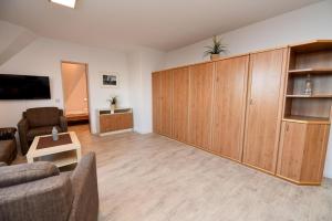 a living room with wooden cabinets and a couch and a table at Ferienwohnung NW 31 Meerblick in Duhnen