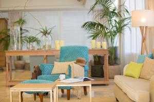 a living room with chairs and a couch and a table at Universal Hotel Neptuno - Adults Only in Playa de Palma