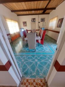 a dining room with a table and chairs on a mosaic floor at Quinta Rubi in Las Rosas +37 photos