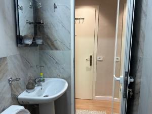 a bathroom with a sink and a toilet and a shower at Meko Apartments in Tirana +44 photos