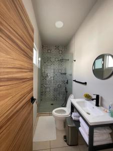 a bathroom with a shower and a toilet and a sink at Casa Cuicári Nuevo vallarta in Nuevo Vallarta 