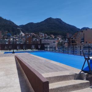 a swimming pool on the roof of a building at Apartaestudio Bacata 960 in Bogotá