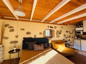 a bedroom with a large bed and a kitchen at Serra da Freita Concept House in Parameira
