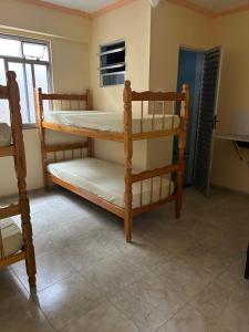 two bunk beds in a room with a window at RoseMarAzul Temporadas in Cabo Frio