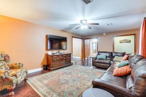 a living room with a leather couch and a television at Less Than 1 Mi to Main St Berryville Spacious Family Home in Berryville