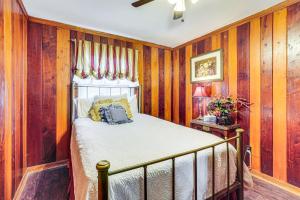 a bedroom with wood paneled walls and a bed at Less Than 1 Mi to Main St Berryville Spacious Family Home in Berryville