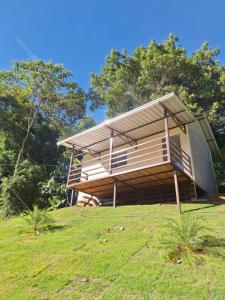 a house on top of a grassy hill at Chalé Roda Dágua B in Alto Caparao +7 photos