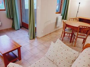 a living room with a table and chairs and a couch at Apartment with parking in Val Cenis in Val Cenis