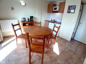 a kitchen with a wooden table and chairs at Apartment for 4 people in Val Cenis in Val Cenis