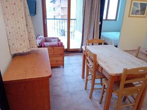 a dining room with a wooden table and chairs at Apartment in Northern Alps with balcony in Val Cenis +12 photos